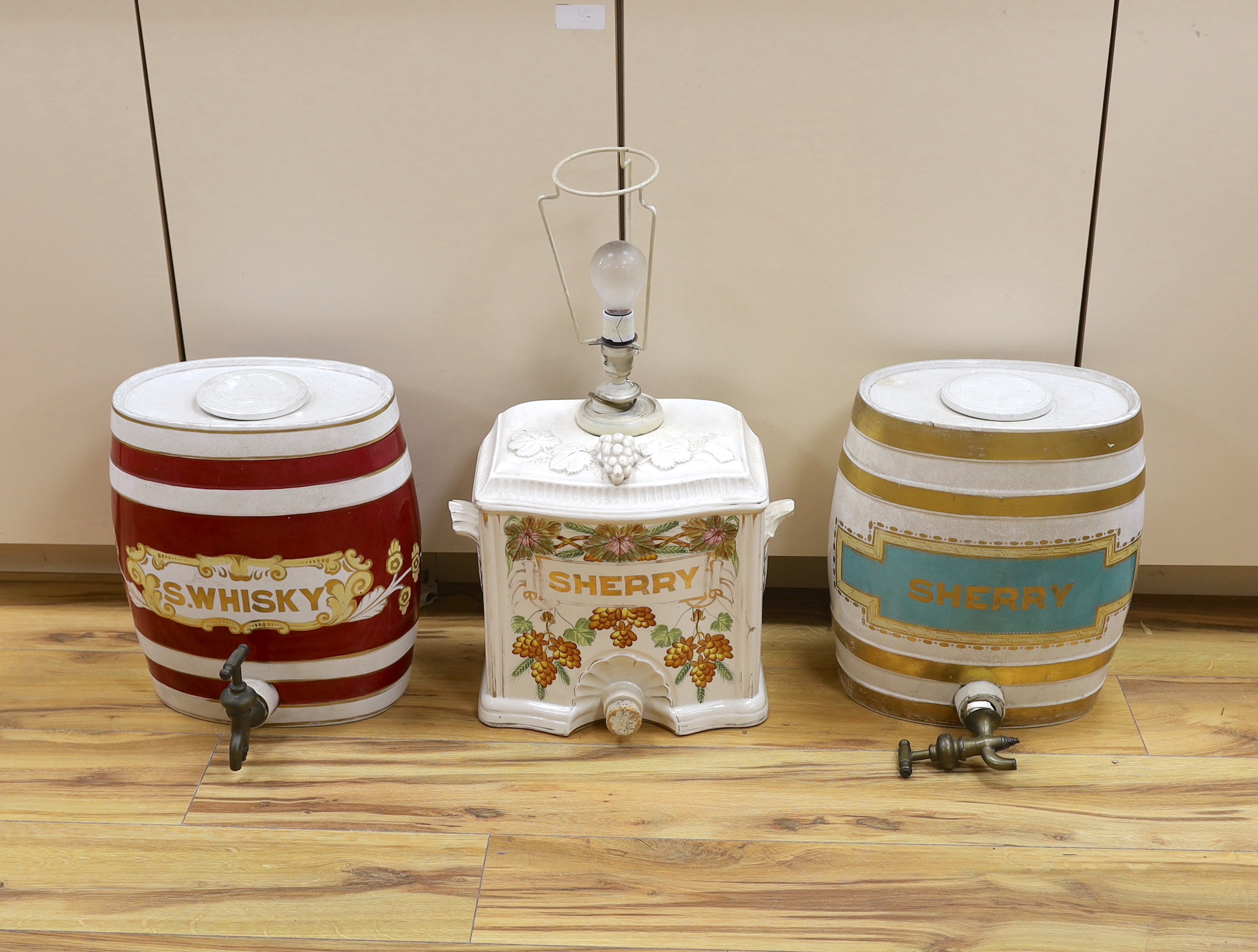 Two pottery sherry barrels (one mounted as a lamp) and flasks and a whisky barrel